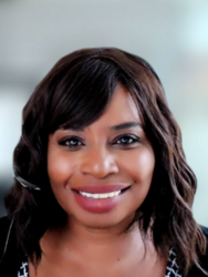 Charmaine Weston, a Black woman who appears to be middle-aged. She has dark brown hair past her shoulders. She smiles.