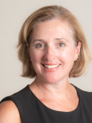 Elizabeth Benton, a middle-aged-appearing white woman with chin-length blonde hair. She wears a sleeveless black top.